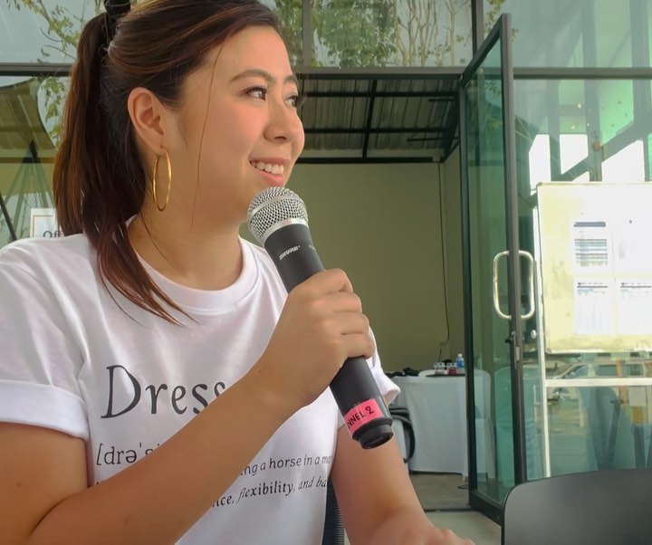 June Siriruk - Trilingual MC holding microphone